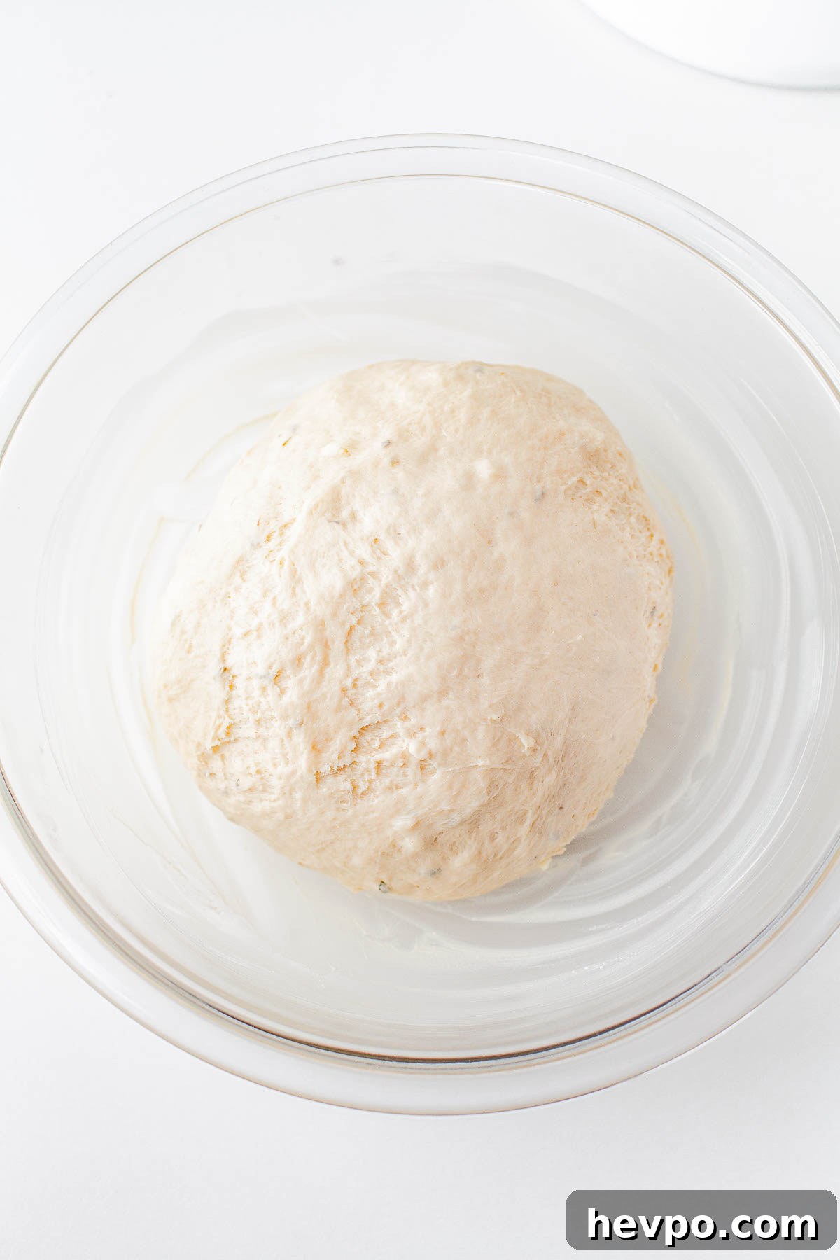 Garlic Herb Rolls dough proofing in a bowl. 