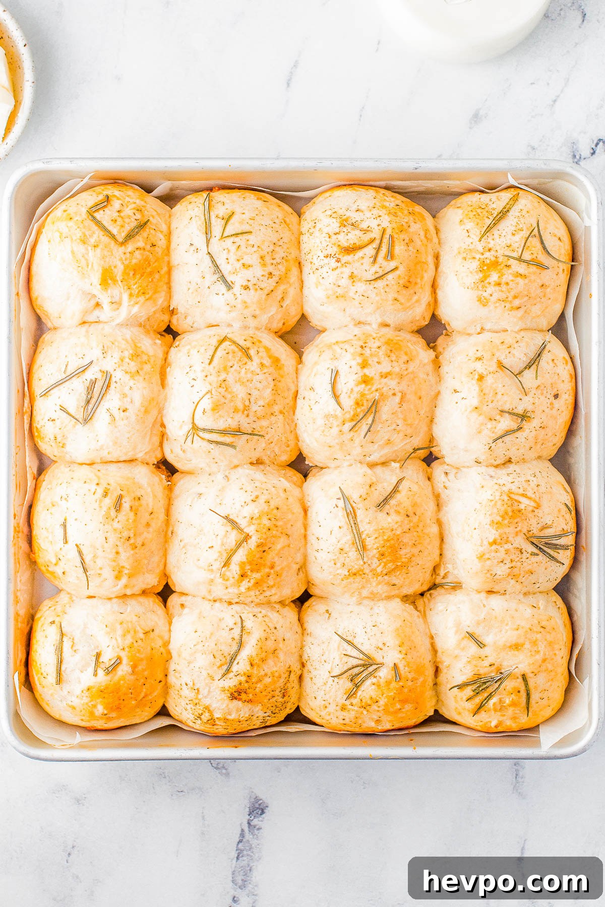 Garlic Herb Rolls in a parchment paper lined baking sheet. 