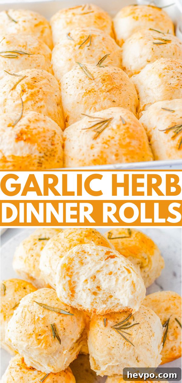 A tray of freshly baked garlic herb dinner rolls, golden brown and sprinkled with rosemary.