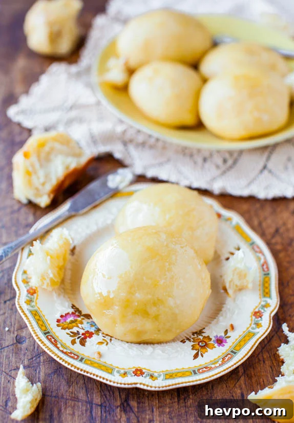 Plates of no-knead rolls with honey butter. 