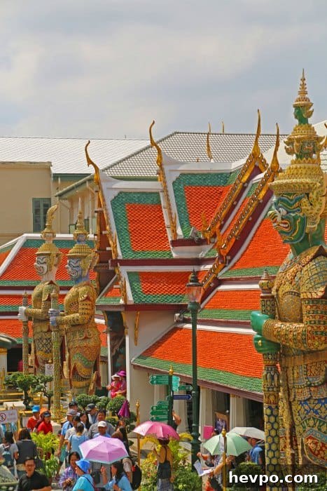 Looking over Tall statues over people in the Grand Palace