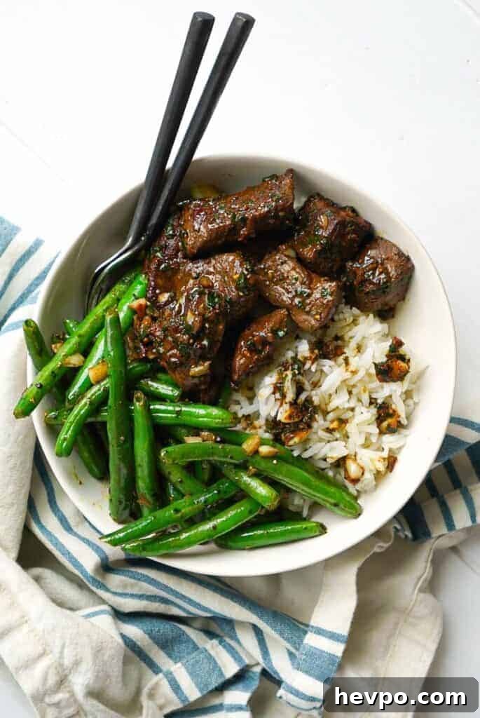 Garlic and Herb Steak Bites: Quick Savory Skillet Recipe 8 A bowl of Garlic Herb Steak Bites with green beans.