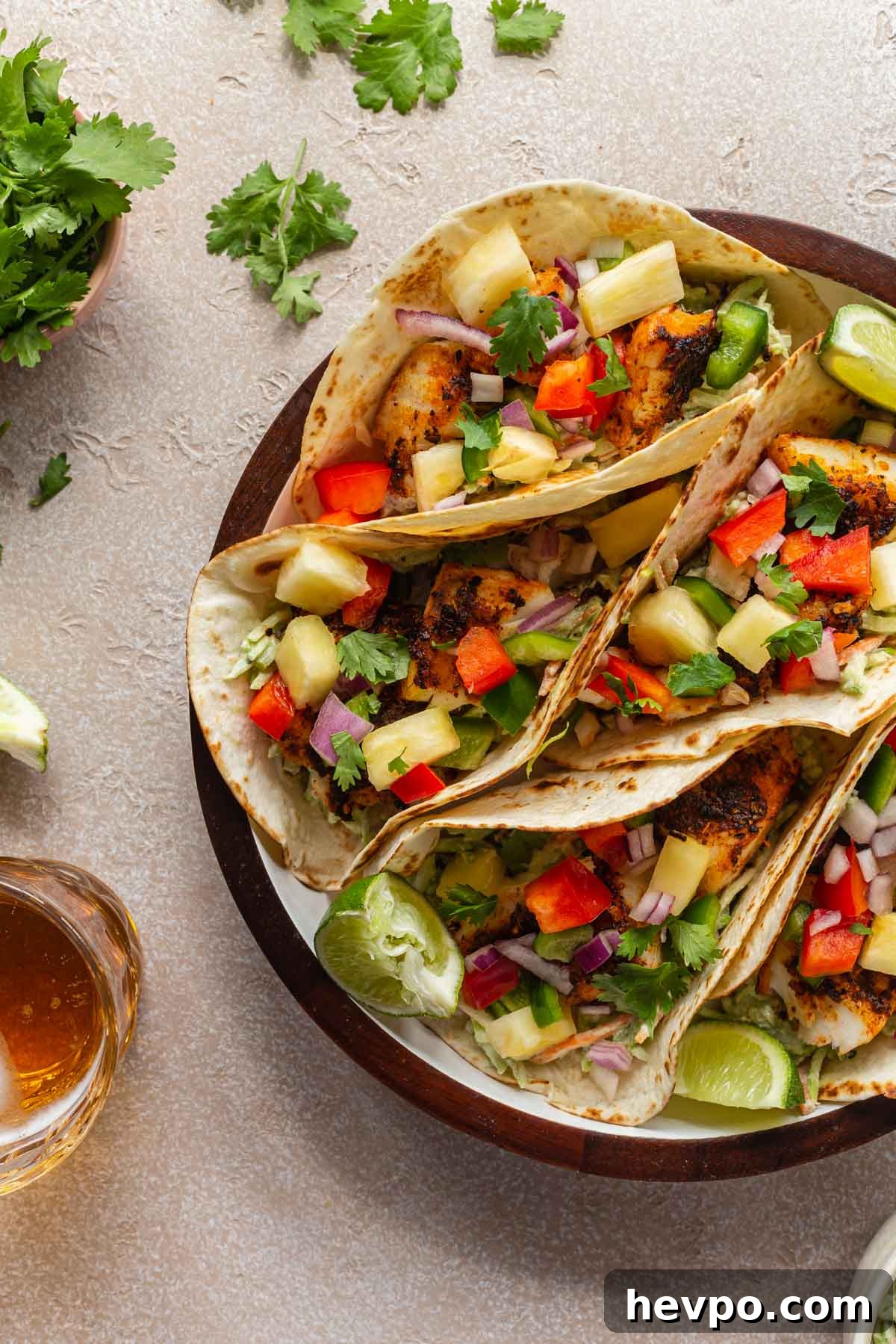 Crispy Air Fryer Fish Tacos with Tangy Slaw and Lime 6 Air fryer fish tacos arranged on a serving tray.
