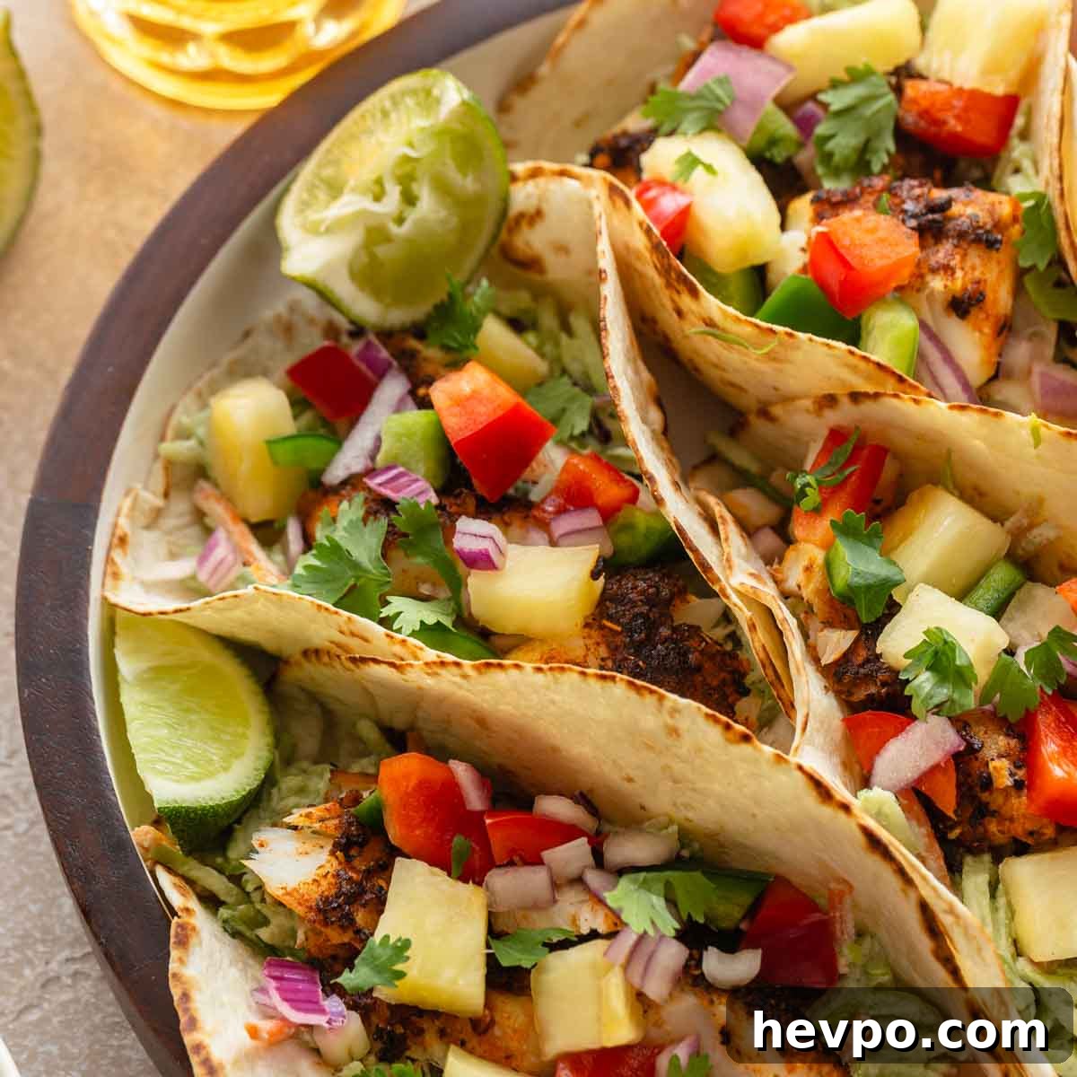 Crispy Air Fryer Fish Tacos with Tangy Slaw and Lime 8 Close up of air fryer fish tacos on a platter.