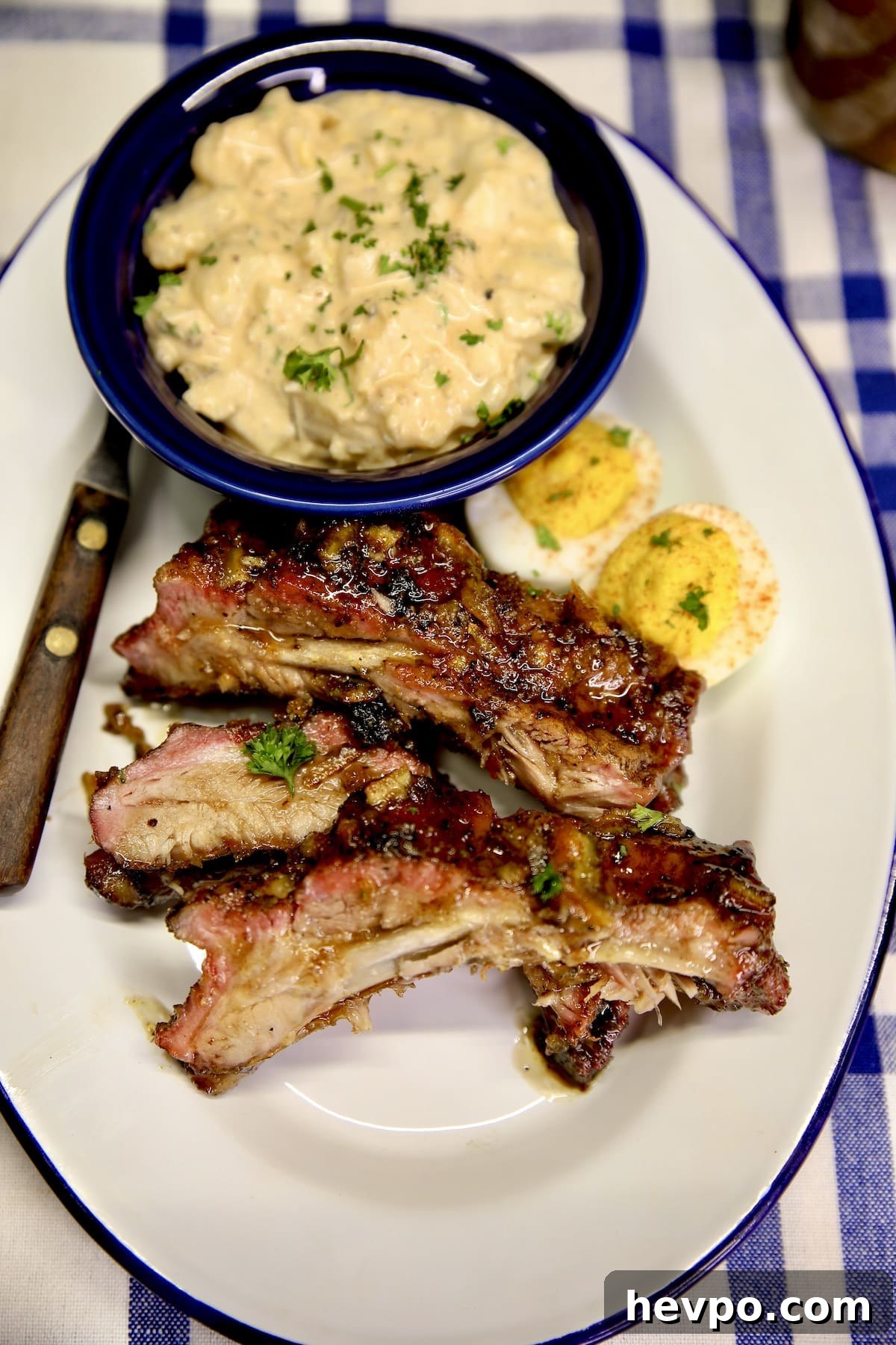 Plate with ribs, potato salad and deviled eggs.