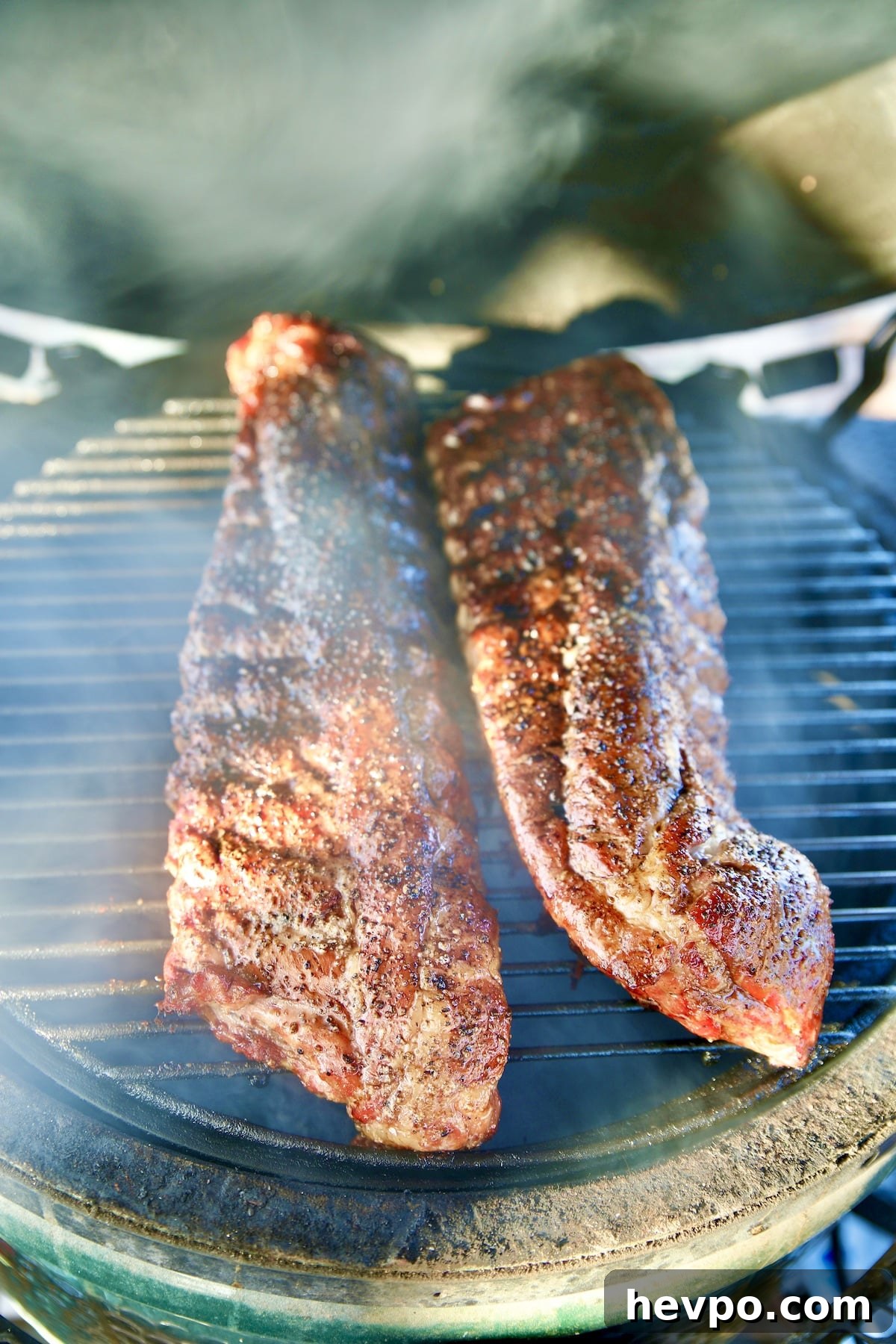 2 racks Baby back ribs on a grill.