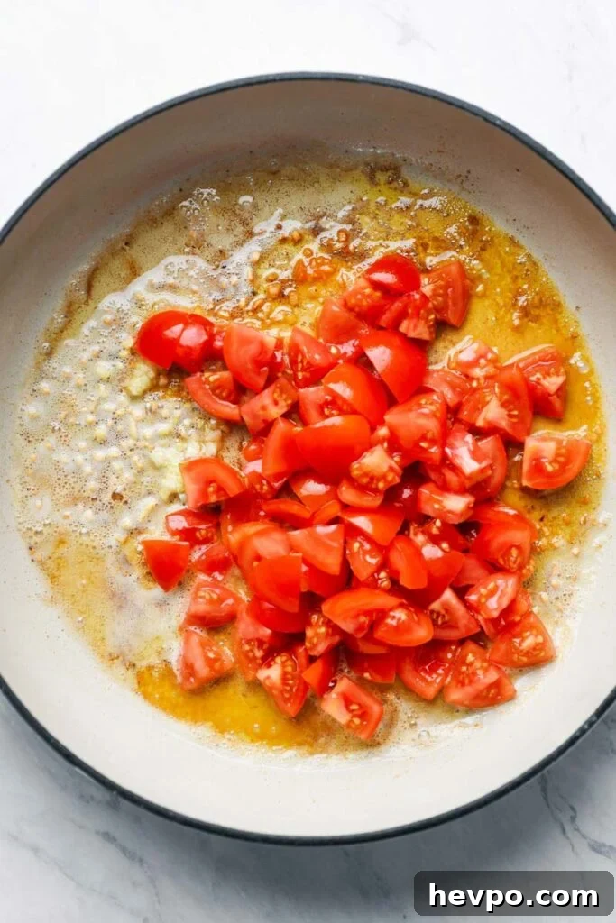 top down view of tomatoes in a skillet