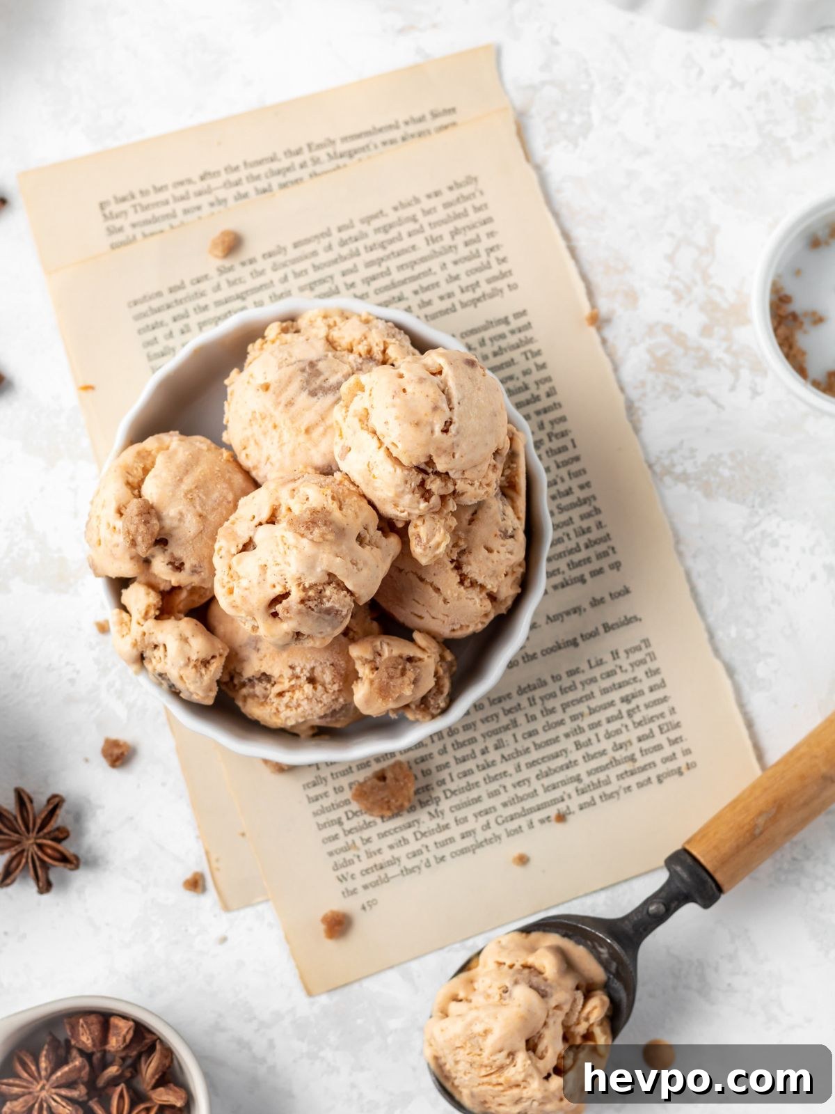Creamy Pumpkin Ice Cream Recipe for Fall Desserts 10 A dish with scoops of pumpkin ice cream and an ice cream scoop.