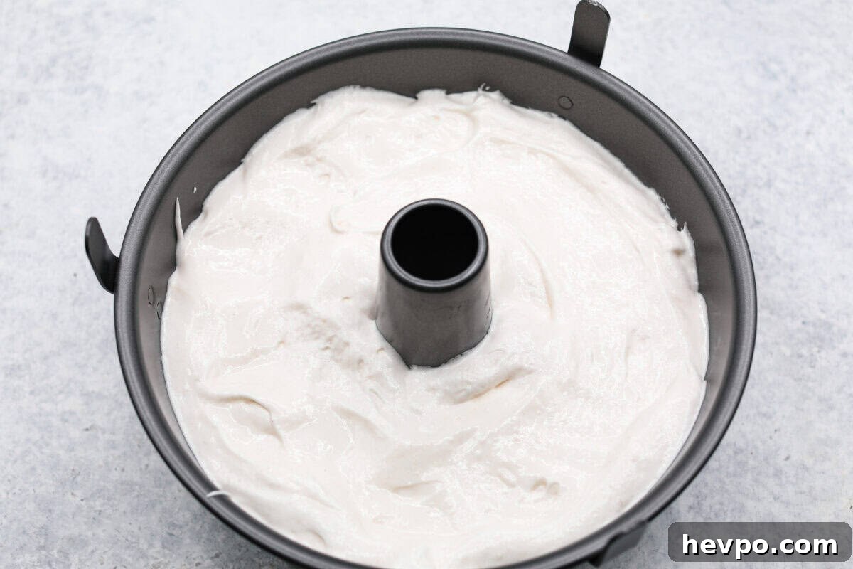 Add the batter to an ungreased tube pan. Overhead shot of angel food cake batter in tube pan.