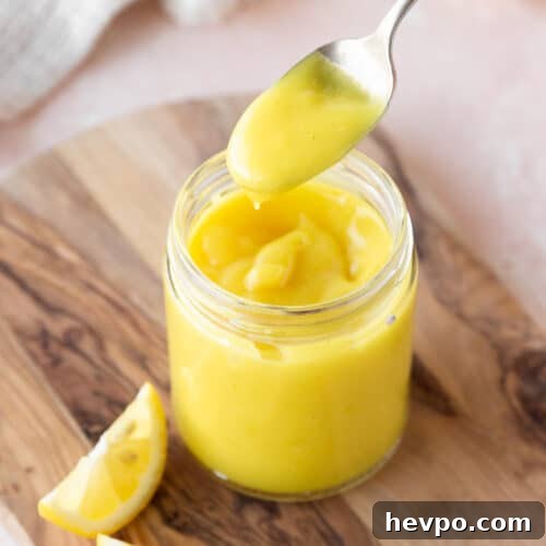 Square hero of vegan lemon curd in a mason jar.