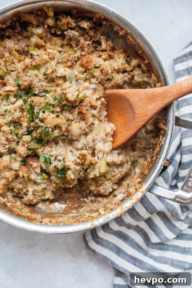 Stainless steel skillet filled with cooked stovetop sausage stuffing