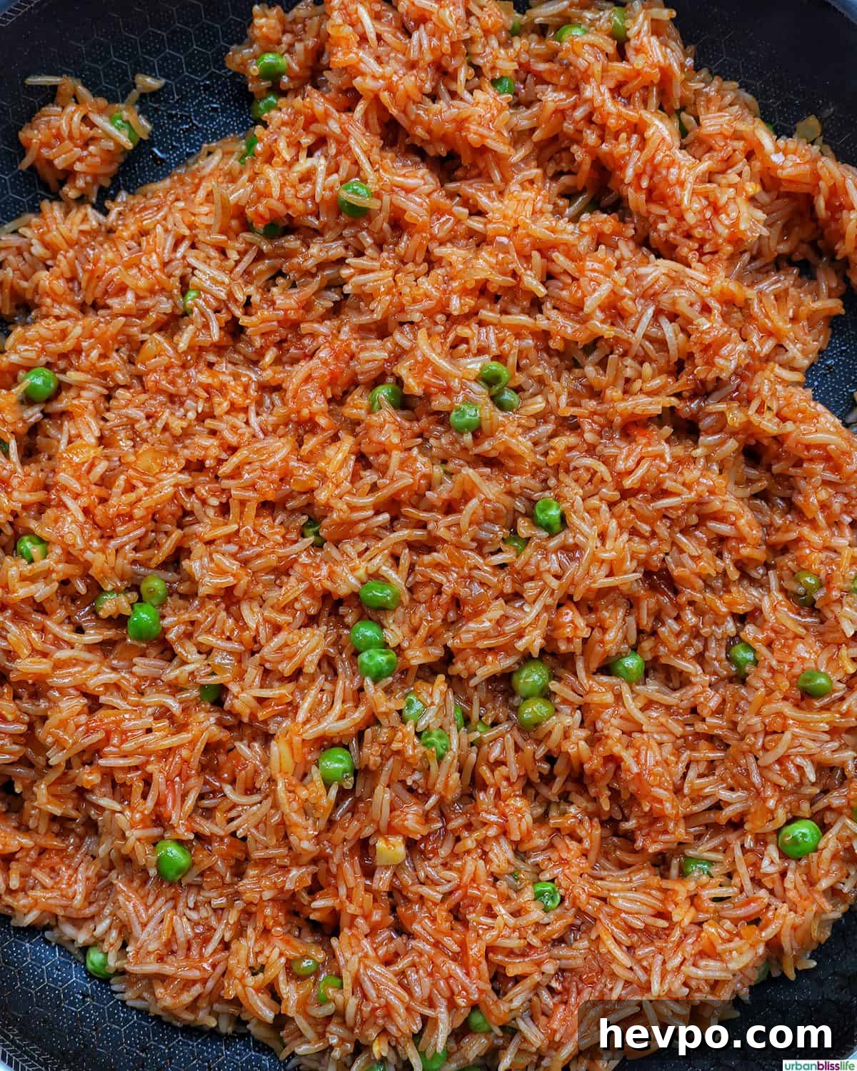 Authentic Vegetarian Mexican Rice Recipe — Flavorful & Simple 12 vegetarian Mexican rice and peas in a skillet.