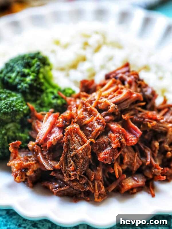 Authentic Vegetarian Mexican Rice Recipe — Flavorful & Simple 19 Mexican shredded beef on a plate with rice and broccoli.