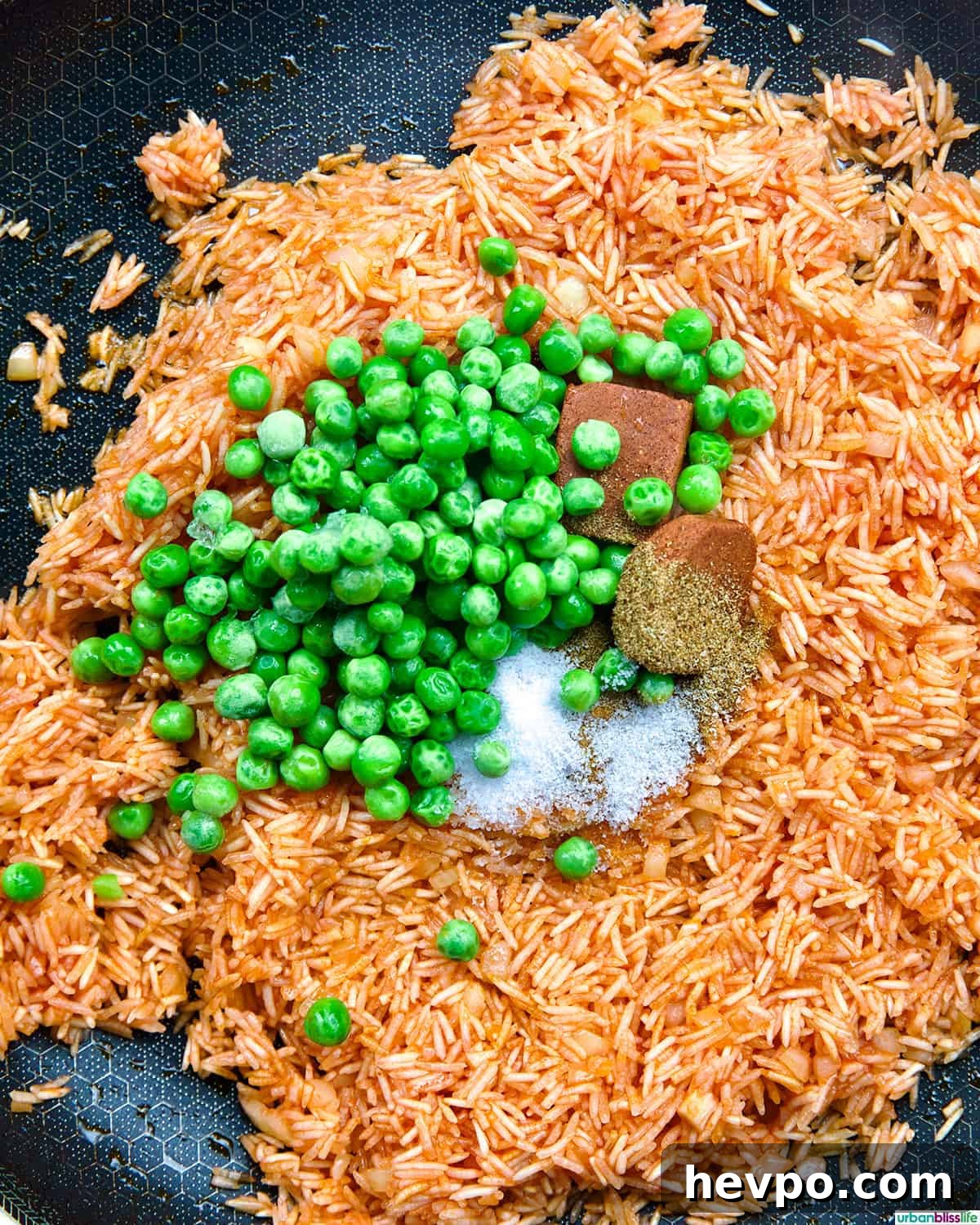 Authentic Vegetarian Mexican Rice Recipe — Flavorful & Simple 8 vegetarian Mexican rice and peas in a skillet.