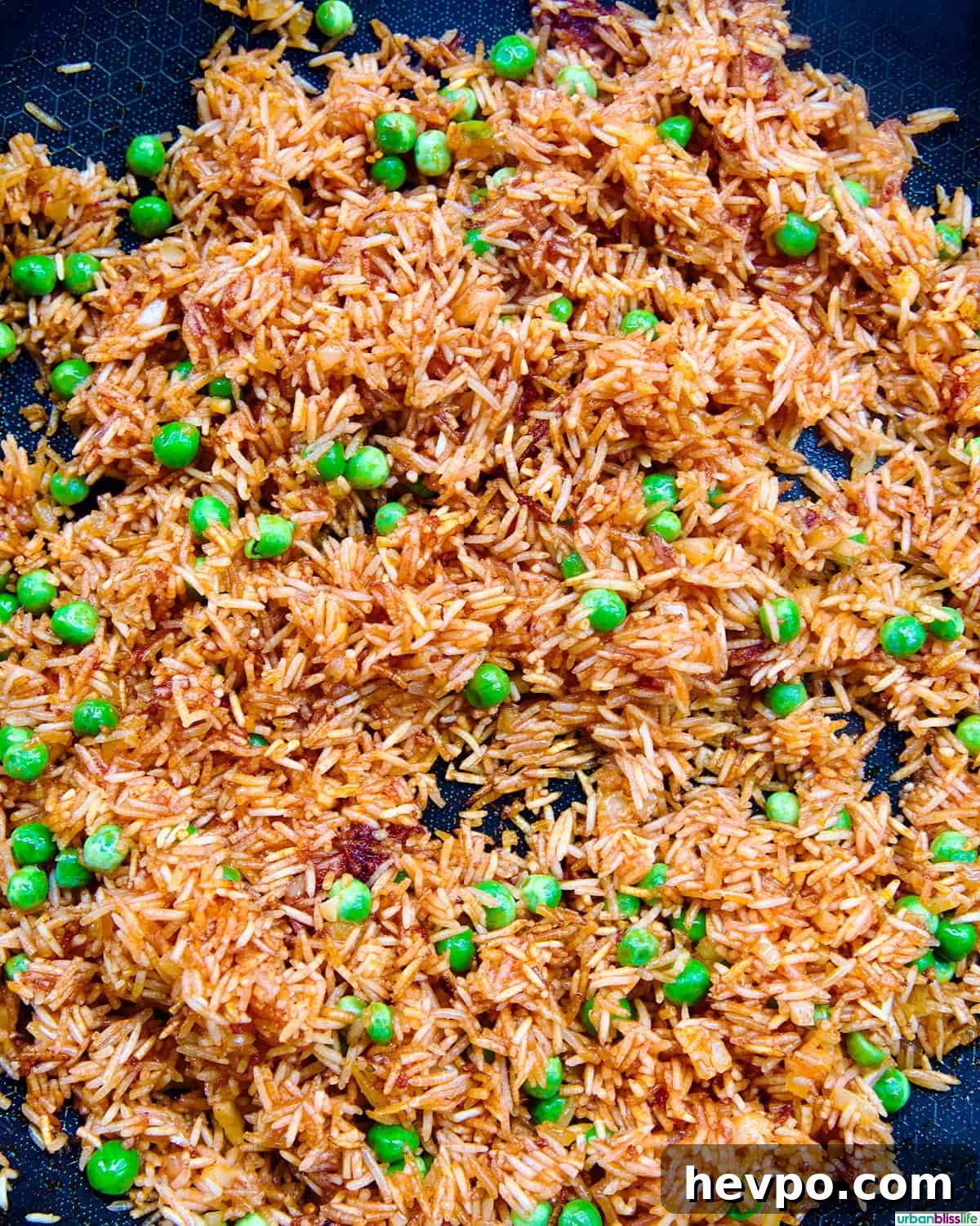 Authentic Vegetarian Mexican Rice Recipe — Flavorful & Simple 9 vegetarian Mexican rice and peas in a skillet.