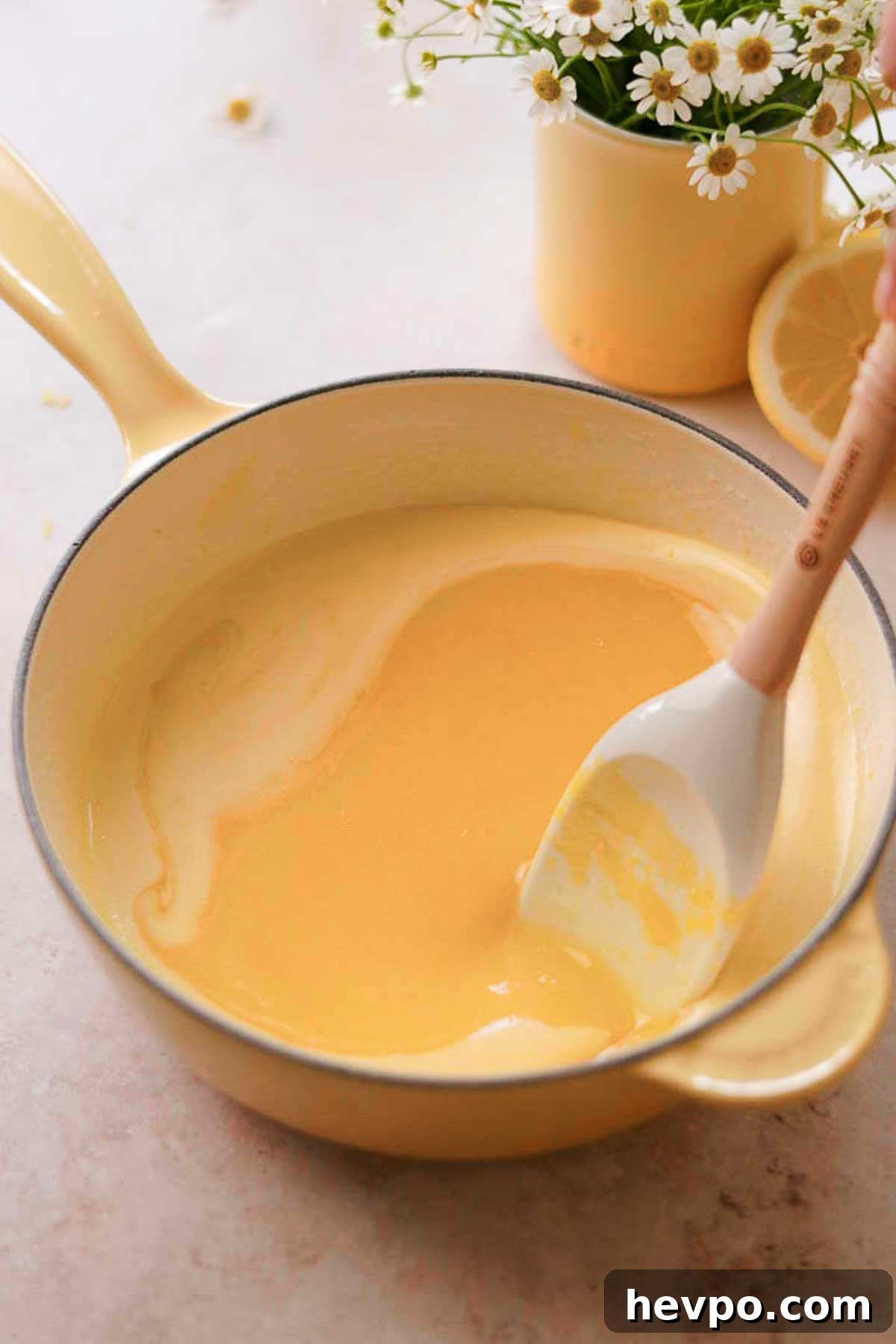 Moist Lemon Poke Cake Recipe with Zesty Lemon Glaze 11 lemon curd wet ingredients mixed in a pot