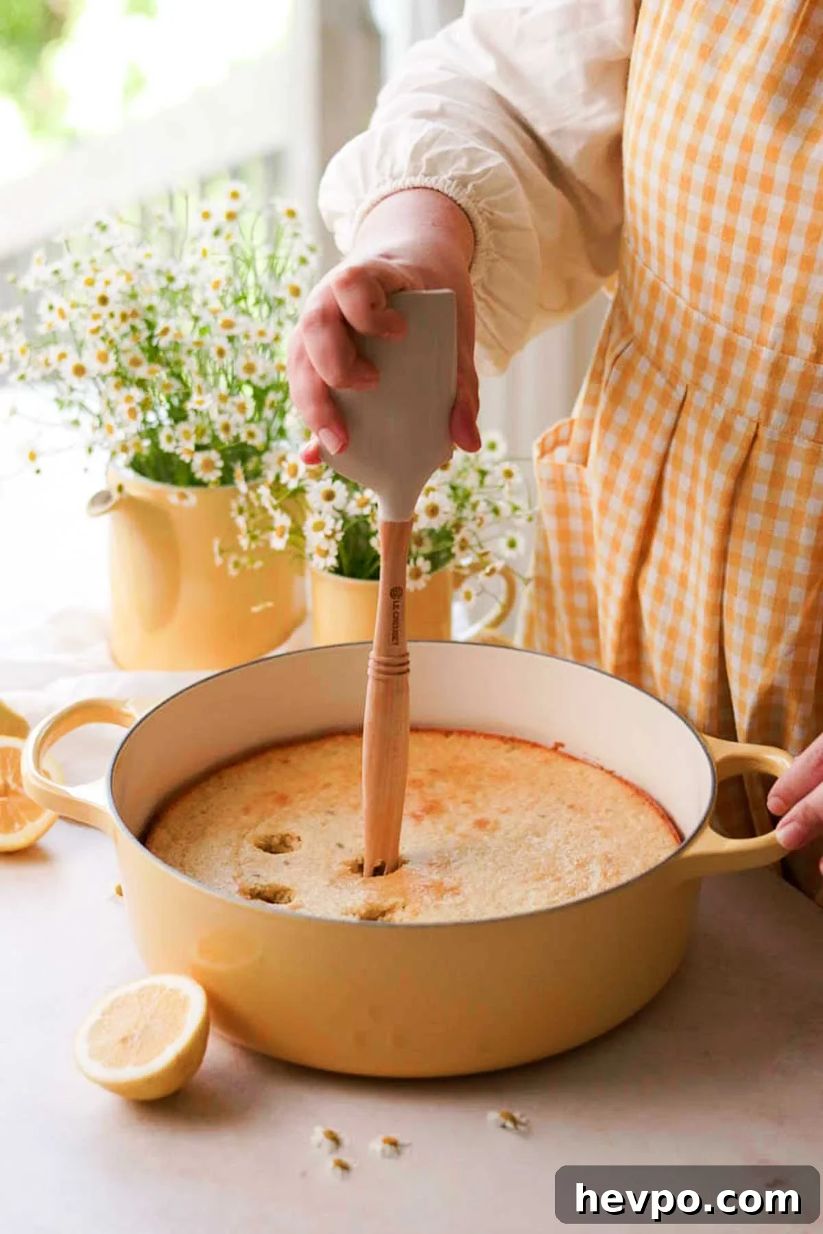 Moist Lemon Poke Cake Recipe with Zesty Lemon Glaze 15 poking holes with the other end of the spatula into the freshly baked lemon cake