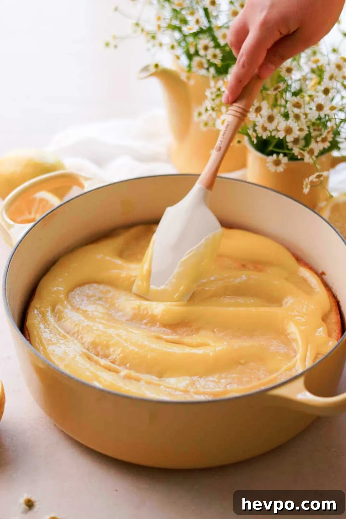 Moist Lemon Poke Cake Recipe with Zesty Lemon Glaze 16 spreading lemon curd on to the freshly baked cake