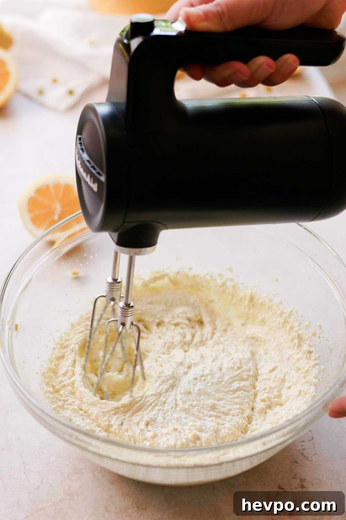 Moist Lemon Poke Cake Recipe with Zesty Lemon Glaze 6 beating oil, butter and sugar together with an electric hand mixer