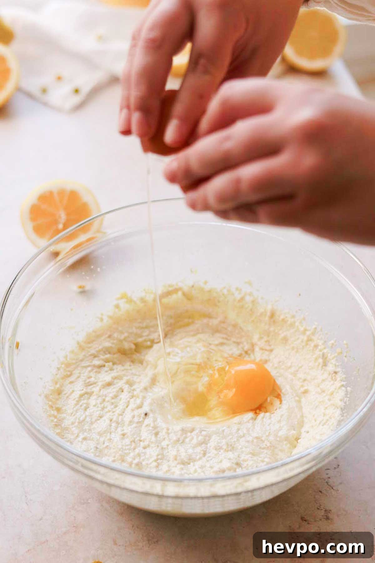 Moist Lemon Poke Cake Recipe with Zesty Lemon Glaze 7 adding eggs one at a time into the batter