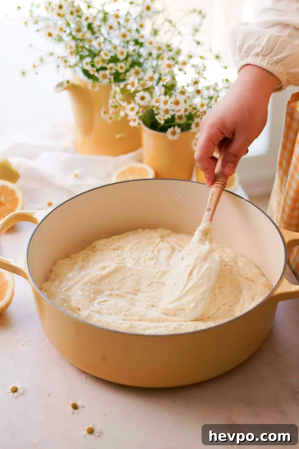 Moist Lemon Poke Cake Recipe with Zesty Lemon Glaze 9 spreading the lemon batter in a dutch oven to bake
