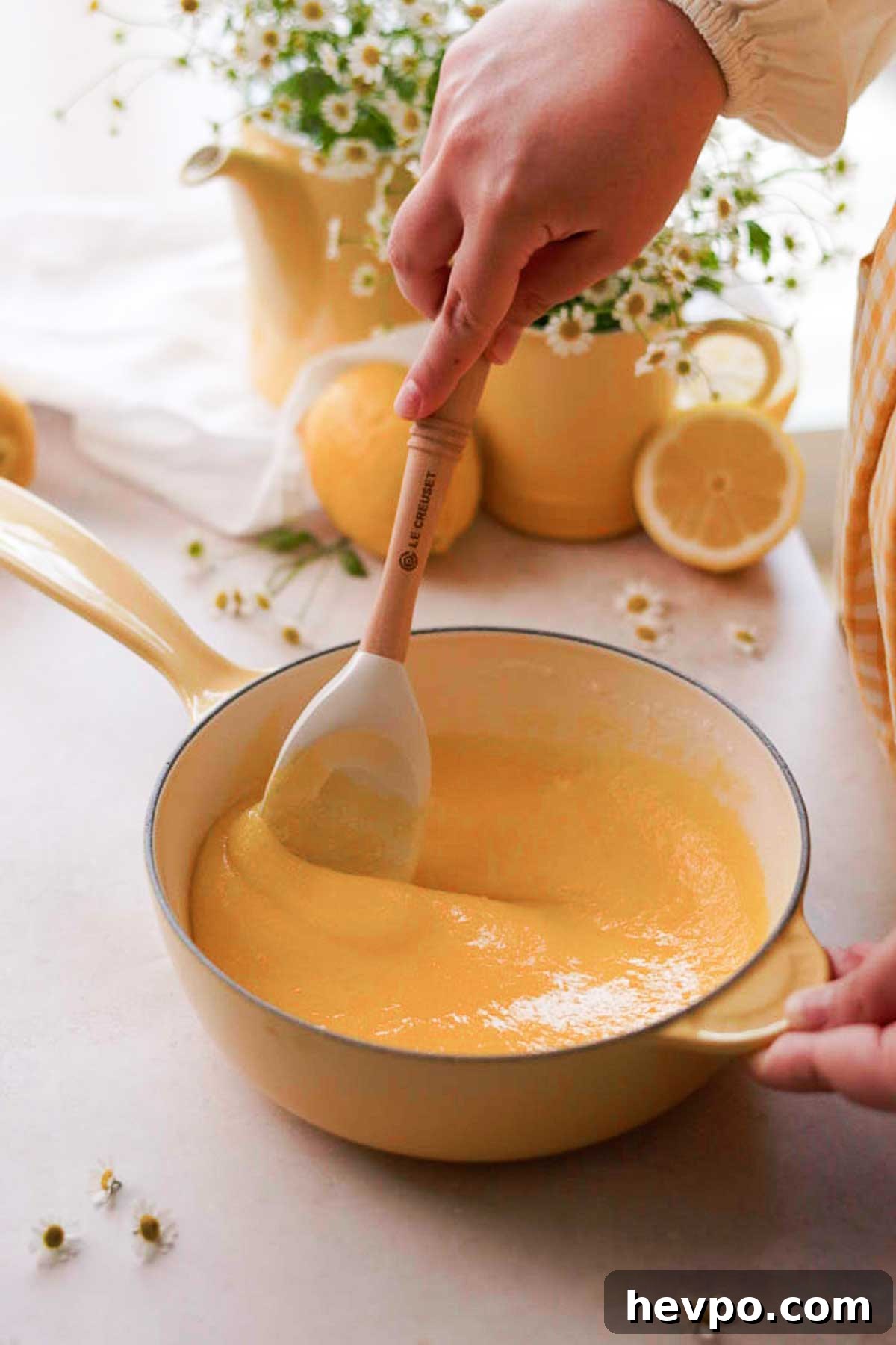 Moist Lemon Poke Cake Recipe with Zesty Lemon Glaze 10 mixing egg yolks and sugar for lemon curd