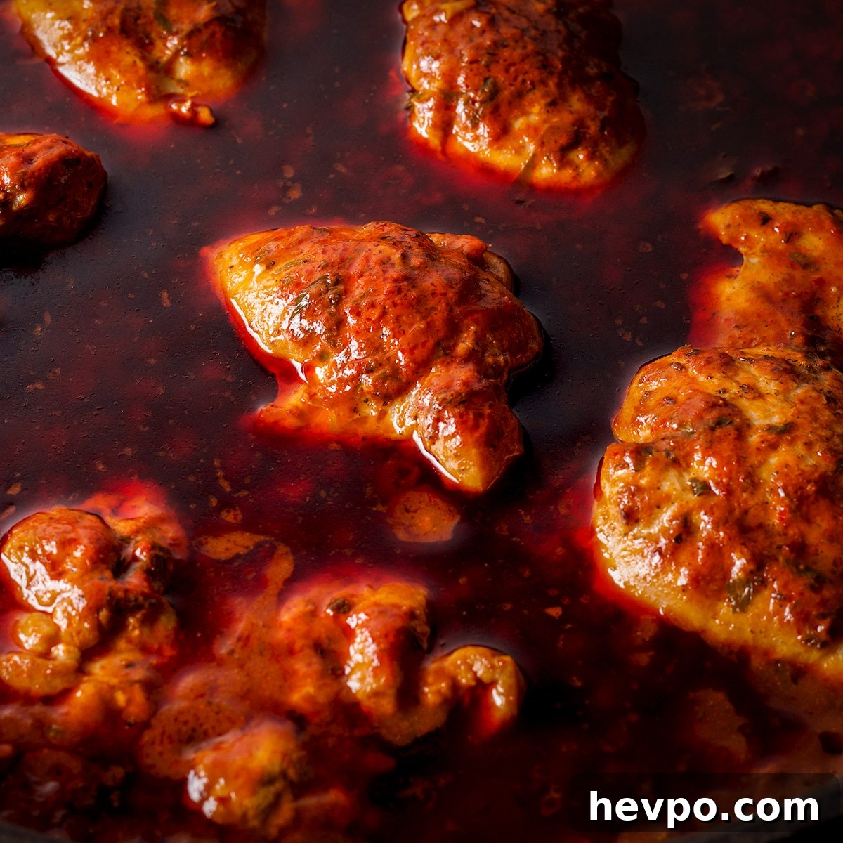 Chicken simmering in Mexican Adobo Sauce.