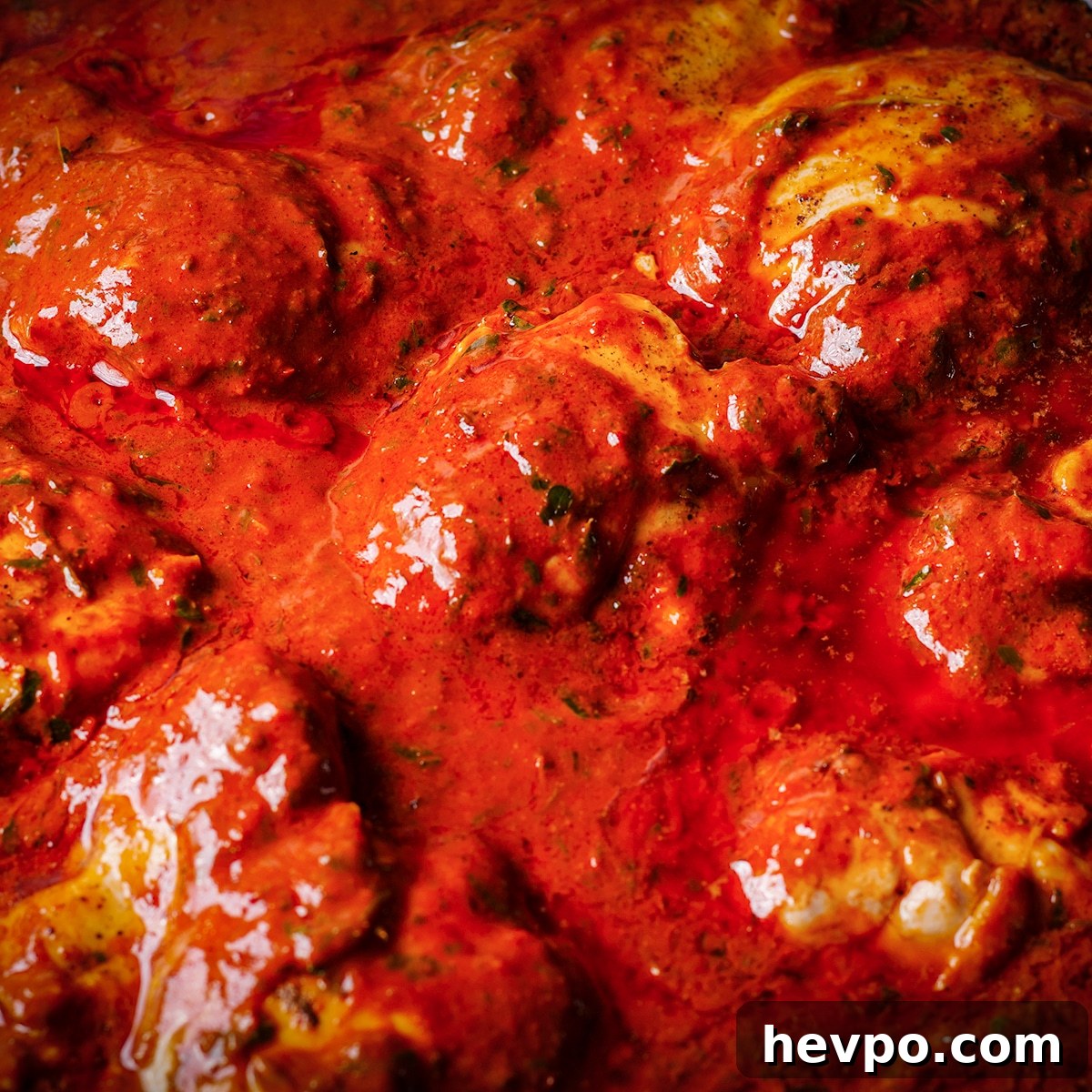 Mexican Chicken Adobo simmering in a hot skillet.
