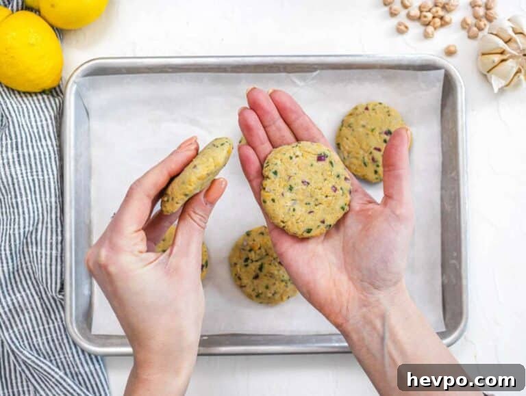 Step 2 Shaping chickpea mixture into small patties on a tray ready to cook.