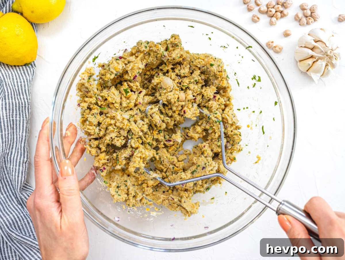 Step 1 Mixing chickpeas onion garlic herbs and spices in a large bowl for patties.