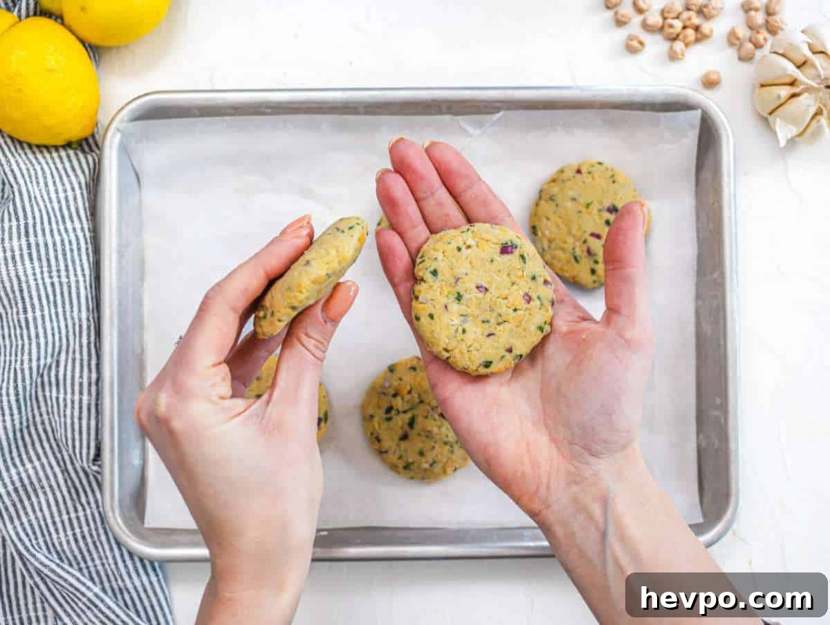 Step 2 Shaping chickpea mixture into small patties on a tray ready to cook.