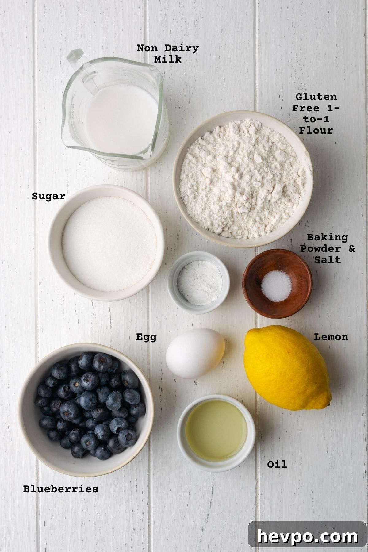 Gluten-Free Lemon Blueberry Muffins Recipe (Moist & Zesty) 3 Ingredients for gluten free lemon blueberry muffins on a white table.