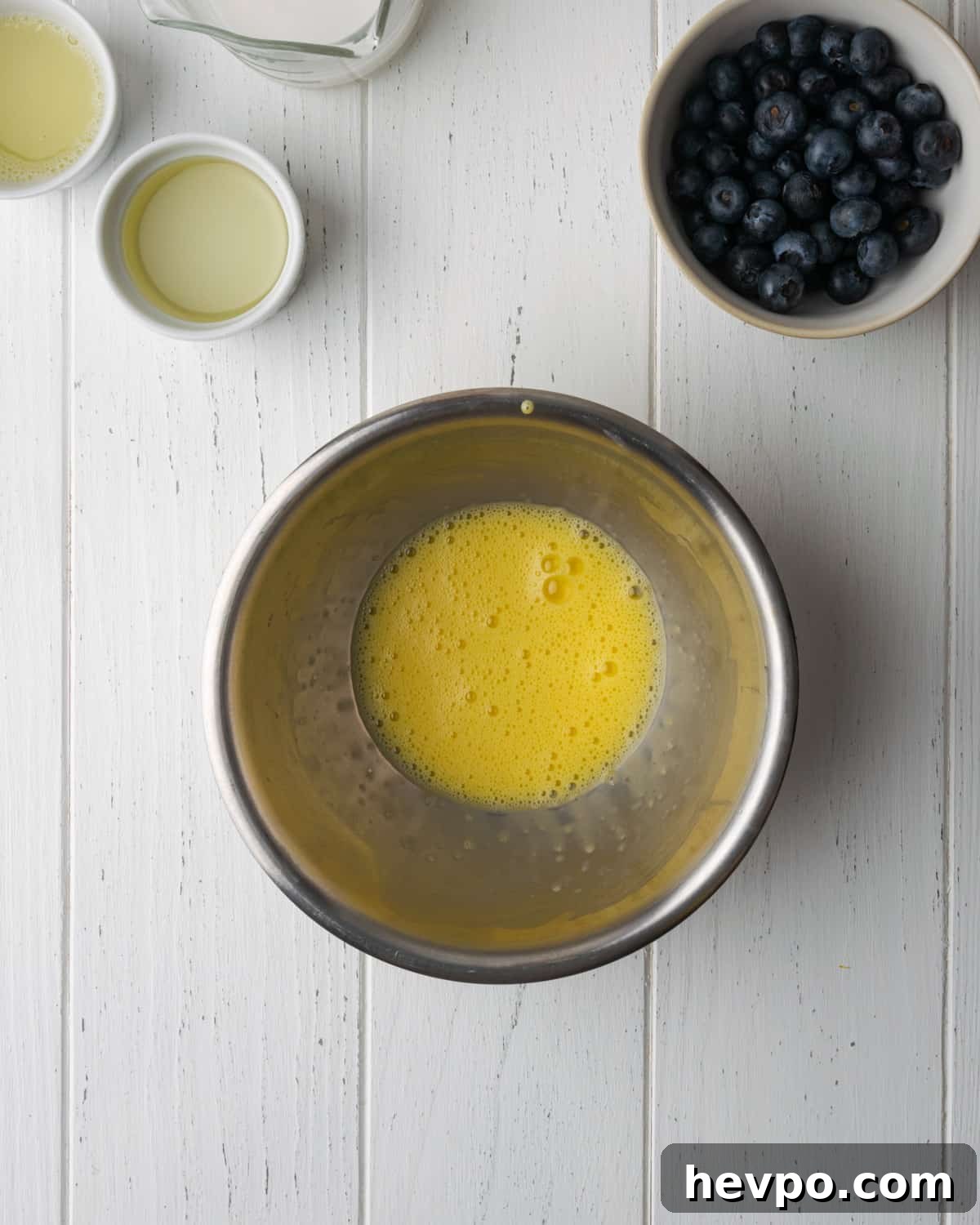 Gluten-Free Lemon Blueberry Muffins Recipe (Moist & Zesty) 5 Egg whisked to a frothy state in a small metal bowl.
