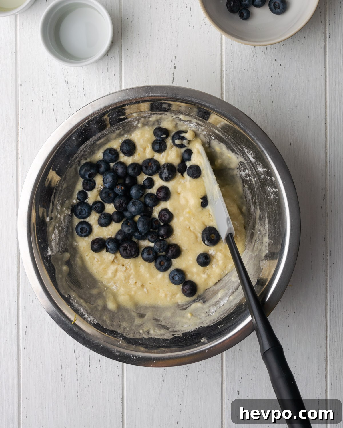 Gluten-Free Lemon Blueberry Muffins Recipe (Moist & Zesty) 8 Blueberries being mixed into batter.