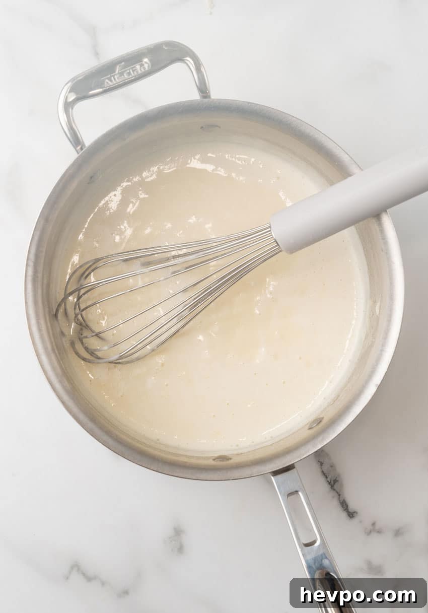 Creamy White Chicken Lasagna Roll-Ups Recipe 5 homemade cream sauce in a large metal skillet