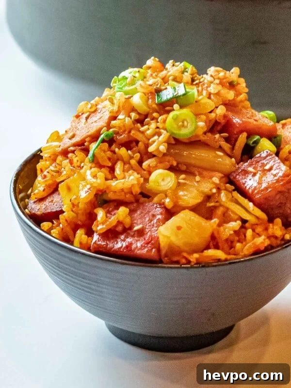 How to Make Spam Musubi: Simple Hawaiian Rice and Nori Snack 8 bowl of kimchi fried rice with spam topped with scallions and sesame seeds