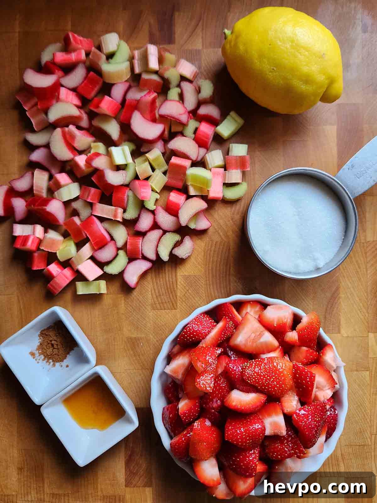 Small-Batch Strawberry Rhubarb Jam Recipe for Perfect Preserves 3 Overhead of ingredients for fruit jam on a wood cutting board.