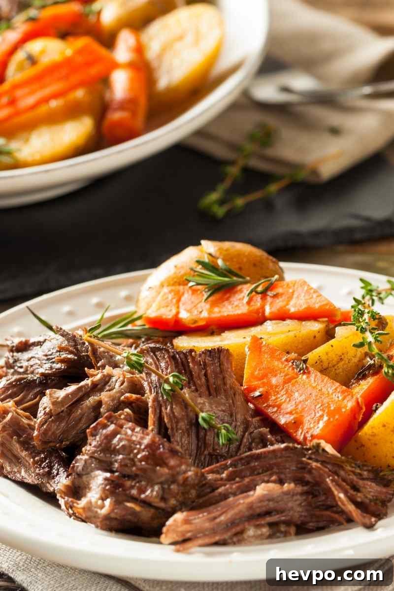 Slow-Cooked Crockpot Chuck Roast Recipe for Tender Beef 2 a plate with pot roast and vegetables on a serving platter.