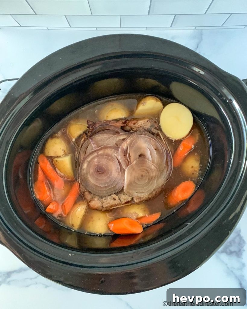 Slow-Cooked Crockpot Chuck Roast Recipe for Tender Beef 6 Adding the potatoes and carrots to the slow cooker pot during the last two hours of cooking