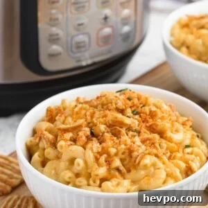instant pot macaroni and cheese in a white bowl with crushed cheese crisps
