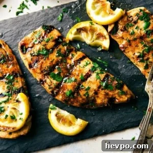 Grilled Chicken Marinade Recipe with Video Tutorial 2 Grilled chicken covered in flavorful chicken marinade and topped with fresh herbs, perfectly cooked and full of flavor.