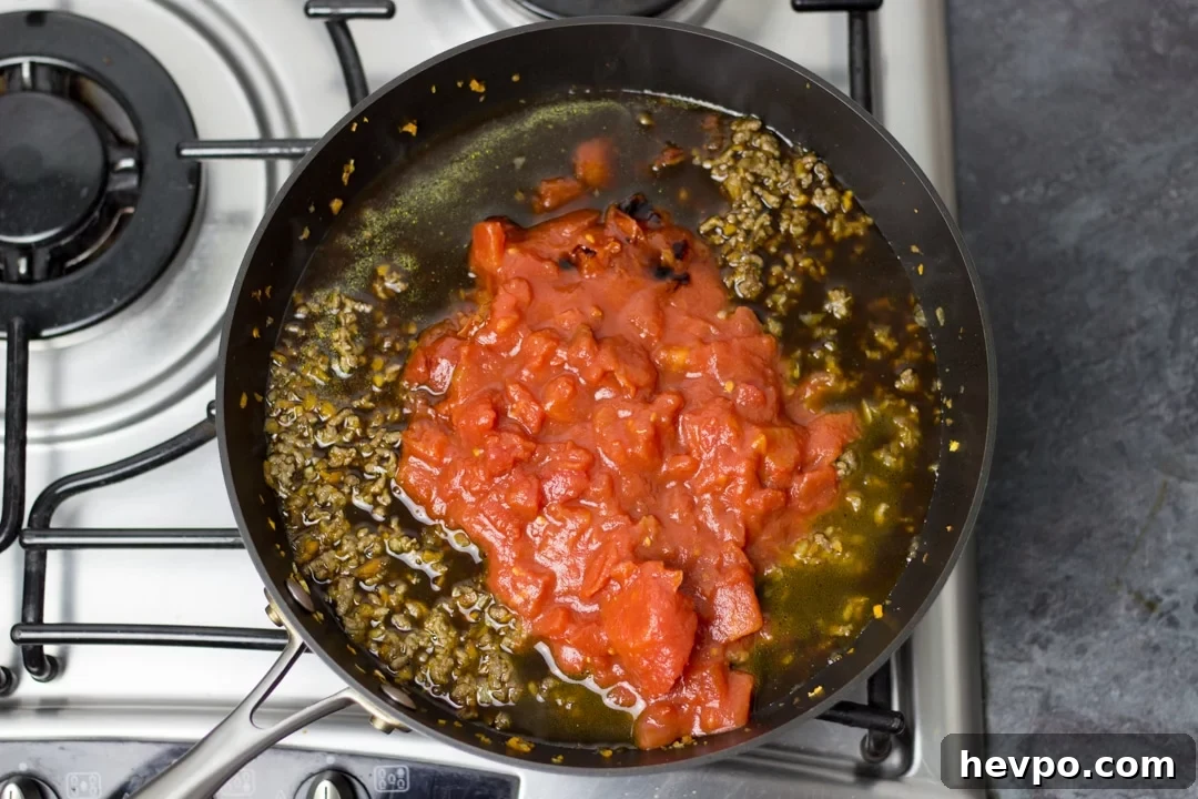 Large saucepan filled with easy spaghetti bolognese ingredients.