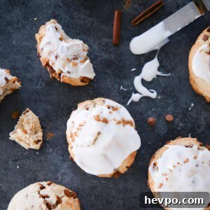 Cinnamon scones with a cream cheese glaze on dark gray surface.