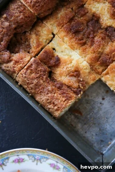 Warm Cinnamon Scones Recipe with Sugar Glaze 9 Cinnamon Flop in antique baking tin sliced.