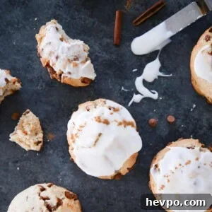 Warm Cinnamon Scones Recipe with Sugar Glaze 10 Cinnamon scones with a cream cheese glaze on dark gray surface.