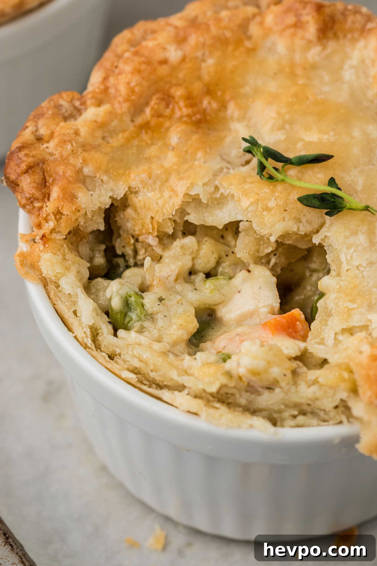 Close up shot of a mini chicken pot pie, with some missing.