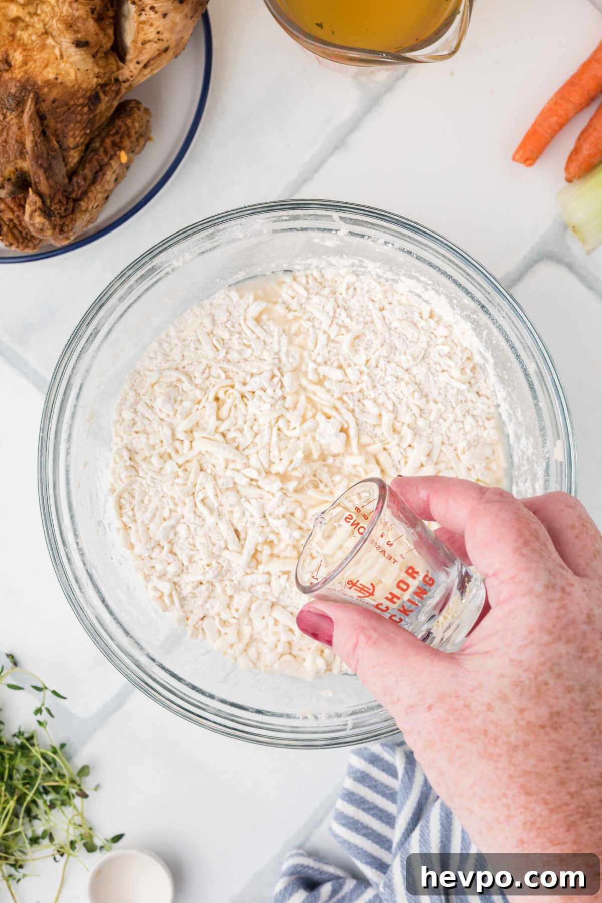 A little iced water being added to a flour mixture.