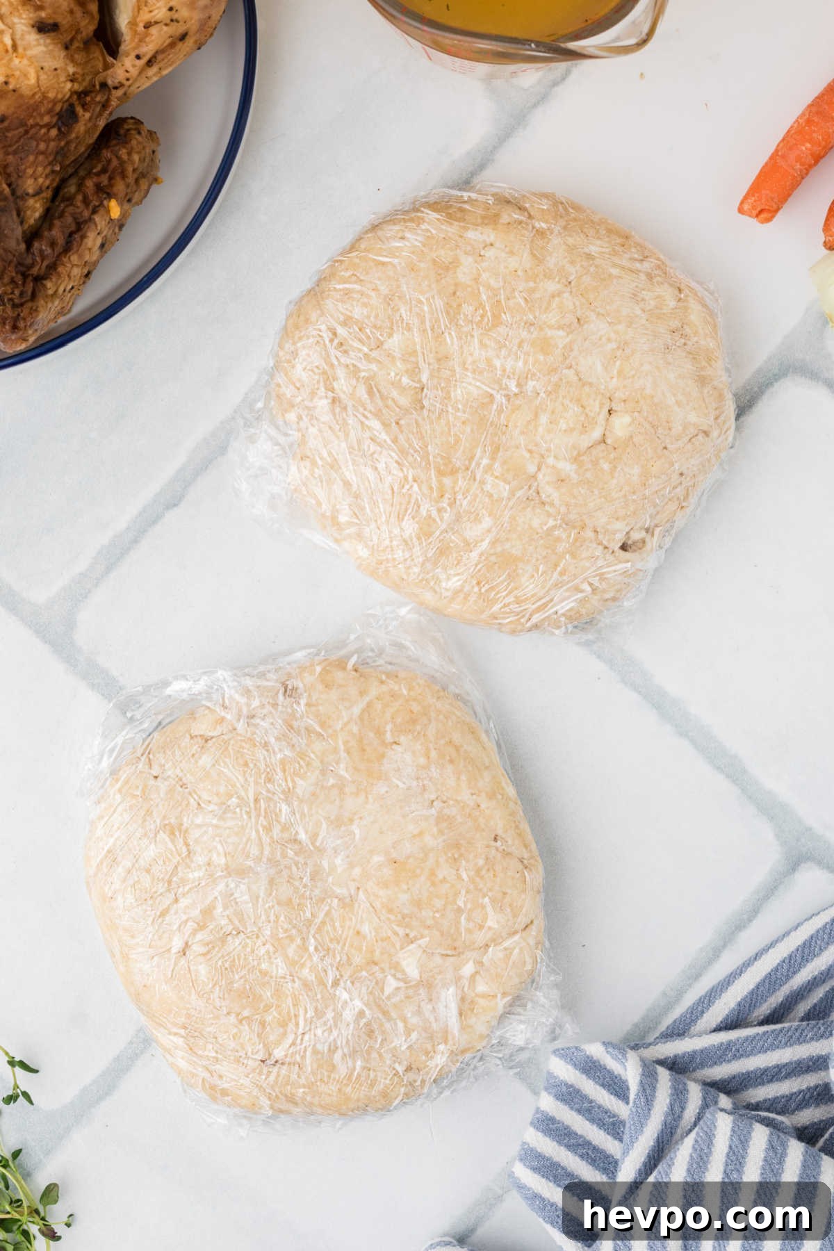Two discs of dough wrapped in plastic wrap.