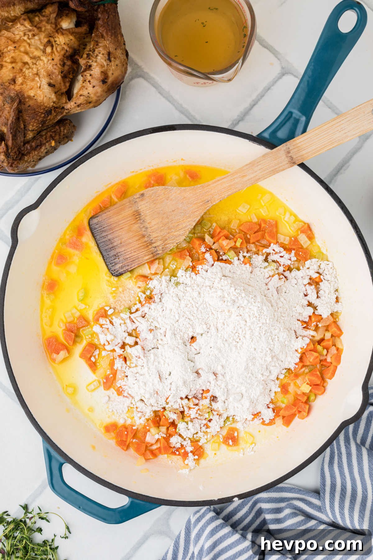 Flour added to a large heavy skillet with carrots, onions and celery.