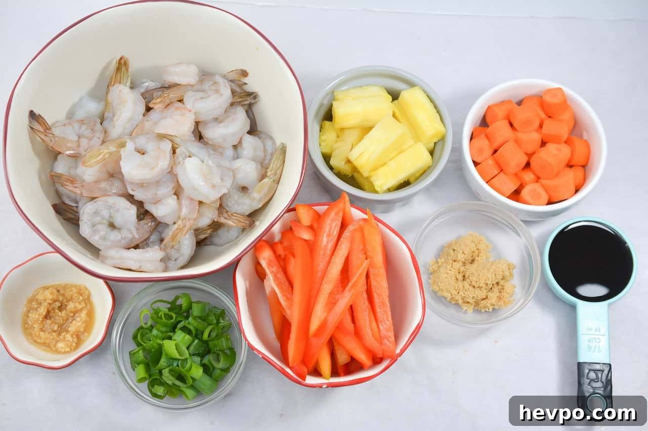 A bowl with shrimp, carrots and other ingredients.